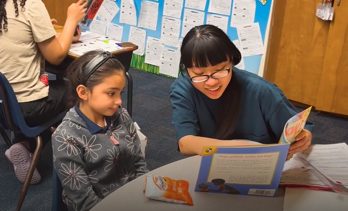 Ngan reading to a student